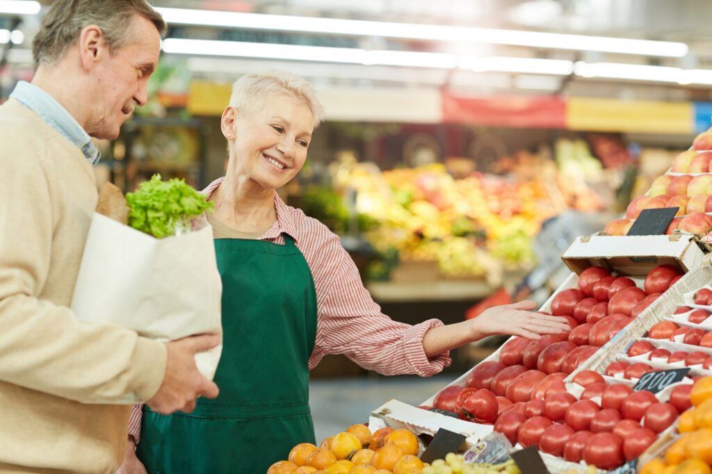 Grocery Store Assistant Helping Customer